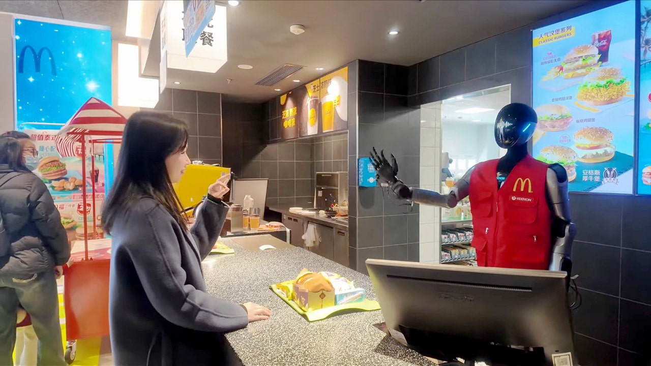 Humanoid robot serving customers at McDonald\